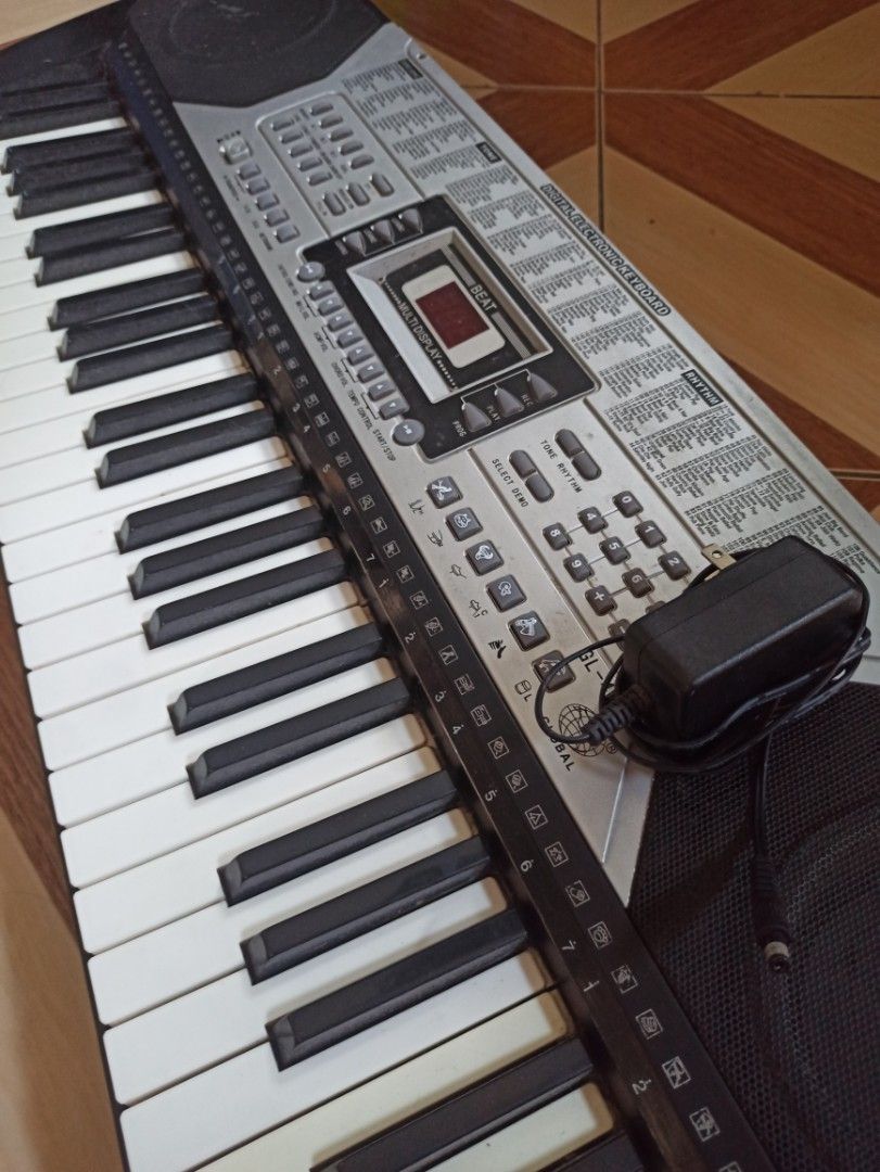 Digital Electronic Keyboard with Power Adapter (Category: Other Home Appliances) located in Manila. Submitted by crafters0001 (Listing ID 1470639480, Image 2). Description: - Type: 54-key digital electronic keyboard (standard layout) - Color: Sleek silver and black control panel - Display: Digital screen showing clear beat numbers - Features: Built-in speakers, various tone and rhythm settings, and a number pad for direct selection - Inclusion: M