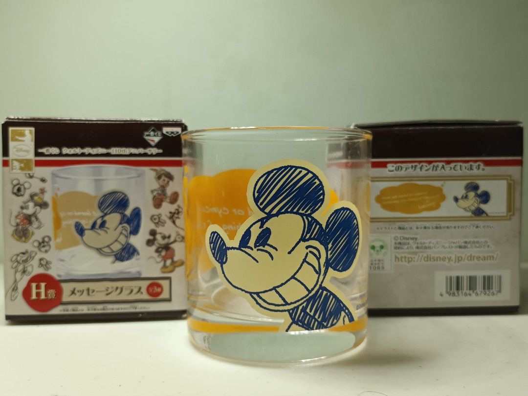 Disney Mickey Mouse 110th Anniversary Message Glass Cup (Category: Character Goods) located in Daet. Submitted by .wenz (Listing ID 1470590051, Image 1). Description: - Official Banpresto Disney 110th Anniversary collectible glass from Japan - Features a vintage Mickey Mouse sketch design with a yellow background - Standard drinking tumbler size - Original retail box included.