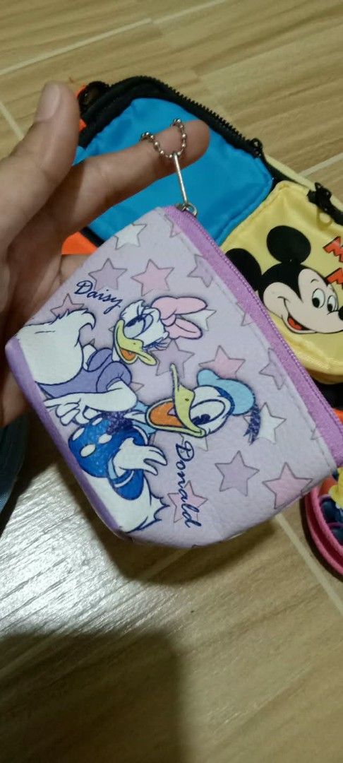 Disney Mickey Mouse Donald Duck Daisy Pouch Bundle Set (Category: Purses & Pouches) located in Gapan. Submitted by montesnora80204 (Listing ID 1470565593, Image 3). Description: Bundle of Disney character pouches and coin purses. Includes a bright orange multi-pocket waist bag with Mickey and blue accents, a light blue Mickey Mouse pencil case with clear front window, a purple Daisy and Donald Duck coin pouch with star pattern, and a round pink M
