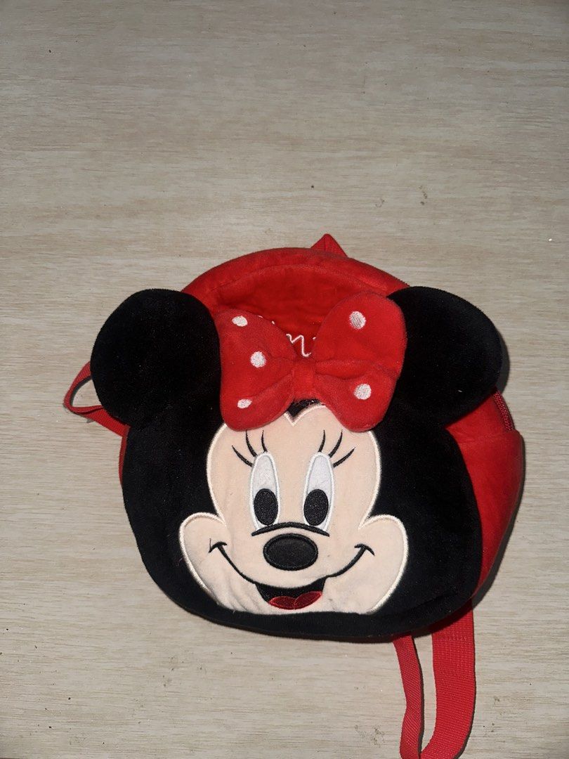 Disney Minnie Mouse red and black mini plush backpack (Category: Babies & Kids Fashion) located in Manila. Submitted by zayzay08 (Listing ID 1470728134, Image 2). Description: - Authentic Disney plush Minnie Mouse backpack in red and black - Features adorable dimensional ears and a polka dot bow on the front - Stylish embroidered Minnie signature script along the side gusset - Soft velour texture all over for a cozy feel - Secure zip closure open