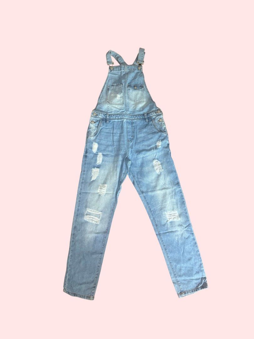 Distressed Denim Overalls (Category: Jumpsuits) located in Pasig City. Submitted by kia.sell (Listing ID 1470652058, Image 1). Description: - Brand: Terranova (100% Authentic) - Style: Full-length distressed denim overalls / dungarees - Color: Light Wash Blue - Design Details: Adjustable overall shoulder straps with metal clasp fasteners, intentional raw shredded rip detailing along the legs, a multi-pocket bib chest layout, classic side-button h