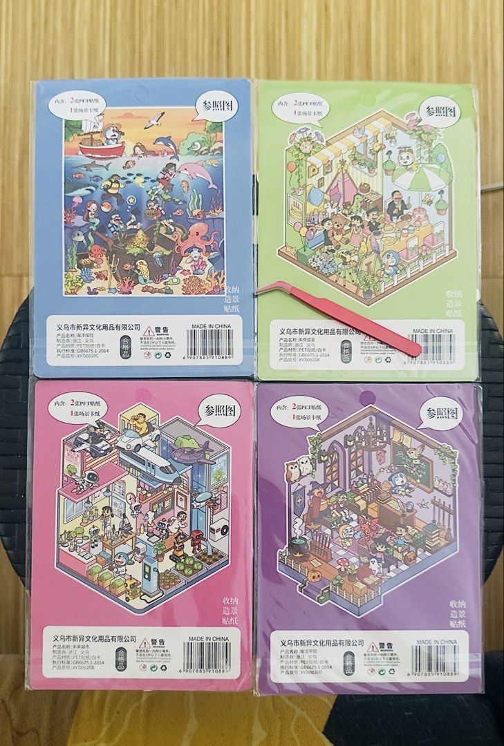 Doraemon Sticker Book with Tweezers (Category: Art & Prints) located in Taguig. Submitted by seek_and_ship (Listing ID 1470617416, Image 2). Description: - Set of 4 scene decorative sticker packs: Underwater Adventure, Food Feast, Future City, and Magic Academy - Each pack includes high-quality PET stickers and a creative scene card - Free pink tweezers included for easy, precise handling - Brand new, unopened, and still in original plastic wrap 