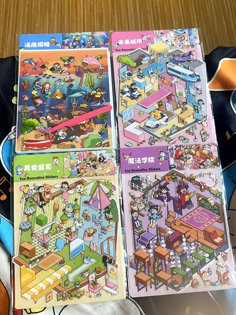 Doraemon Sticker Book with Tweezers (Category: Art & Prints) located in Taguig. Submitted by seek_and_ship (Listing ID 1470617416, Image 1). Description: - Set of 4 scene decorative sticker packs: Underwater Adventure, Food Feast, Future City, and Magic Academy - Each pack includes high-quality PET stickers and a creative scene card - Free pink tweezers included for easy, precise handling - Brand new, unopened, and still in original plastic wrap 