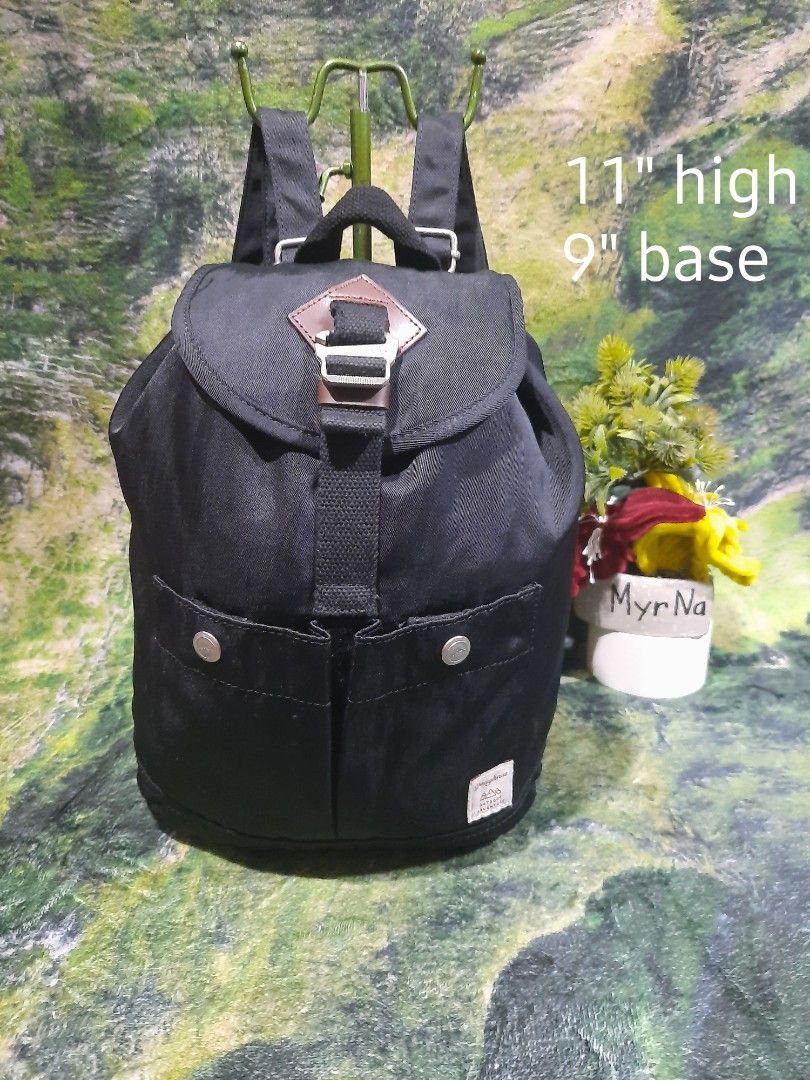 Doughnut Outdoor Adventure Black Backpack (Category: Backpacks) located in Baguio. Submitted by klayblakeb87803 (Listing ID 1470658554, Image 1). Description: - Brand: Doughnut Outdoor Adventure - Color: Solid black with tan inner lining - Dimensions: 11" height x 9" base - Closure: Flap top with buckle & secure drawstring main compartment - Pockets: Dual front snap pockets - Straps: Adjustable shoulder straps - Condition: Excellent / Well-mainta