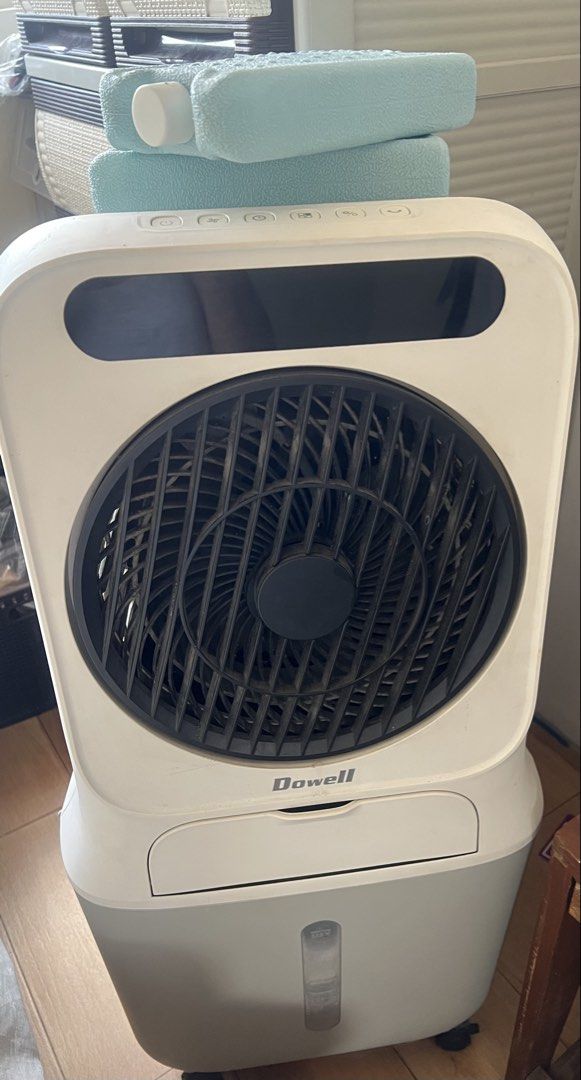 Dowell Air Cooler with Ice Packs (Category: Air Conditioning and Heating) located in General Trias. Submitted by lantiskumeo_9302 (Listing ID 1470578875, Image 1). Description: - Brand: Dowell - Color: White and grey with a stylish black front grille - Condition: Works great, perfect for beating the heat - Features: Top control panel, easy-view water level window at the bottom, and wheels for mobility - Includes: 2 blue ice packs.