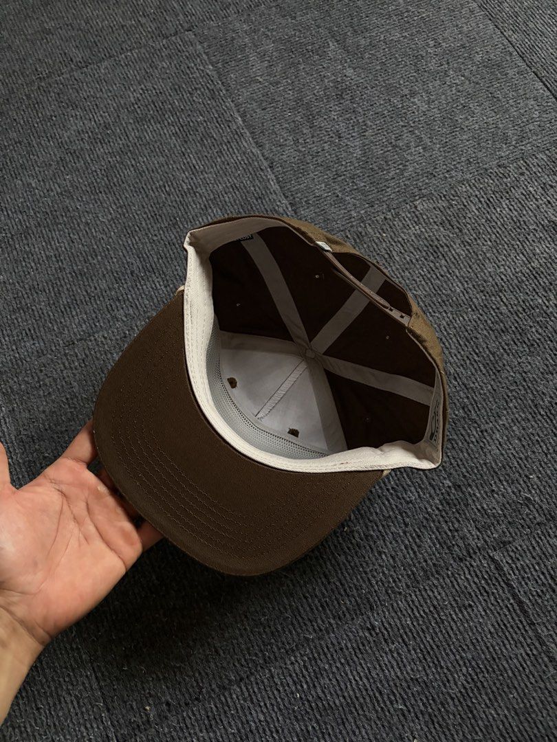 Drake Waterfowl Brown Snapback Cap (Category: Caps & Hats) located in Manila. Submitted by toys_hats005 (Listing ID 1470629528, Image 3). Description: - Brand/Style: Drake Waterfowl snapback hat in brown - Design: Structured crown, flat brim, and stylish contrast rope detail across the front - Details: Front patch logo and Lost brand tab at the back snap - Comfort: Clean inside lining with custom branded taping - Condition/Fit: Adjustable snap cl