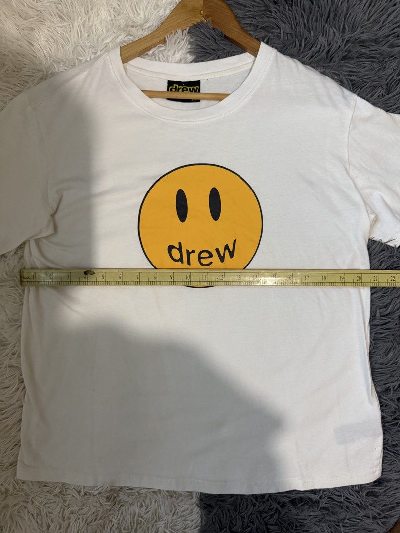 Drew House Mascot SS Tee White XL (Category: Tshirts & Polo Shirts ) located in Manila. Submitted by keepercollection (Listing ID 1470587807, Image 3). Description: - Brand: Drew House - Style: Short sleeve t-shirt - Color: White with iconic yellow smiley face graphic - Size: XL (Tag at collar) - Measurements: Pit to pit 22.5 inches, Length 27 inches - Condition: Excellent - Mode of Payment: GCash, Bank Transfer - Shipping: Via J&T Express or LBC