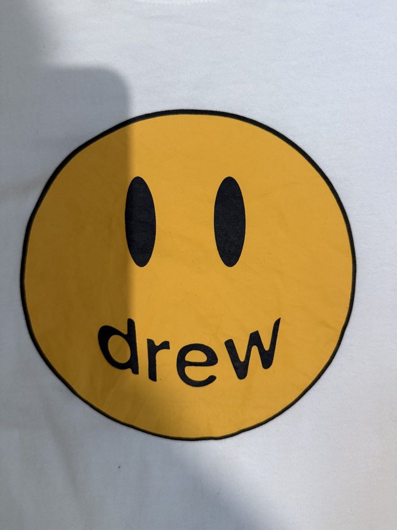 Drew House Mascot SS Tee White XL (Category: Tshirts & Polo Shirts ) located in Manila. Submitted by keepercollection (Listing ID 1470587807, Image 2). Description: - Brand: Drew House - Style: Short sleeve t-shirt - Color: White with iconic yellow smiley face graphic - Size: XL (Tag at collar) - Measurements: Pit to pit 22.5 inches, Length 27 inches - Condition: Excellent - Mode of Payment: GCash, Bank Transfer - Shipping: Via J&T Express or LBC