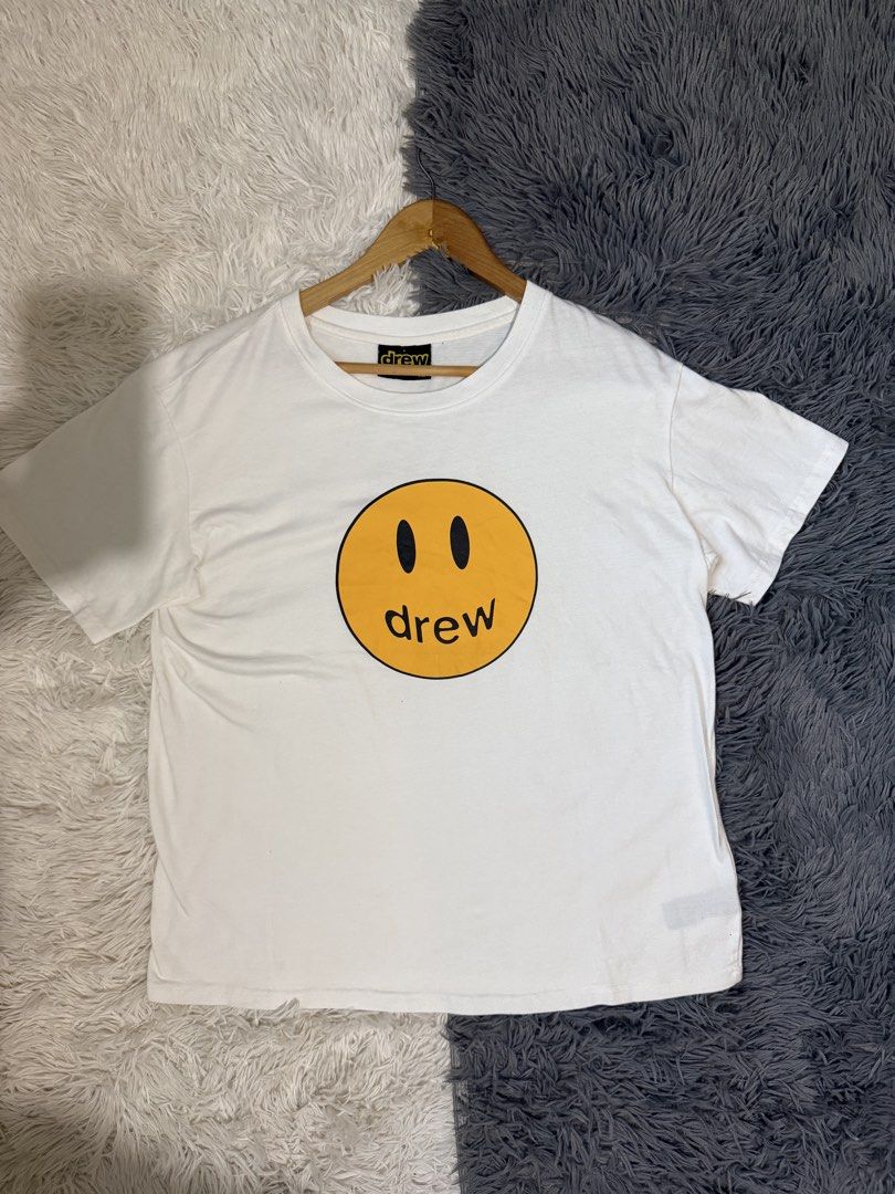 Drew House Mascot SS Tee White XL (Category: Tshirts & Polo Shirts ) located in Manila. Submitted by keepercollection (Listing ID 1470587807, Image 1). Description: - Brand: Drew House - Style: Short sleeve t-shirt - Color: White with iconic yellow smiley face graphic - Size: XL (Tag at collar) - Measurements: Pit to pit 22.5 inches, Length 27 inches - Condition: Excellent - Mode of Payment: GCash, Bank Transfer - Shipping: Via J&T Express or LBC
