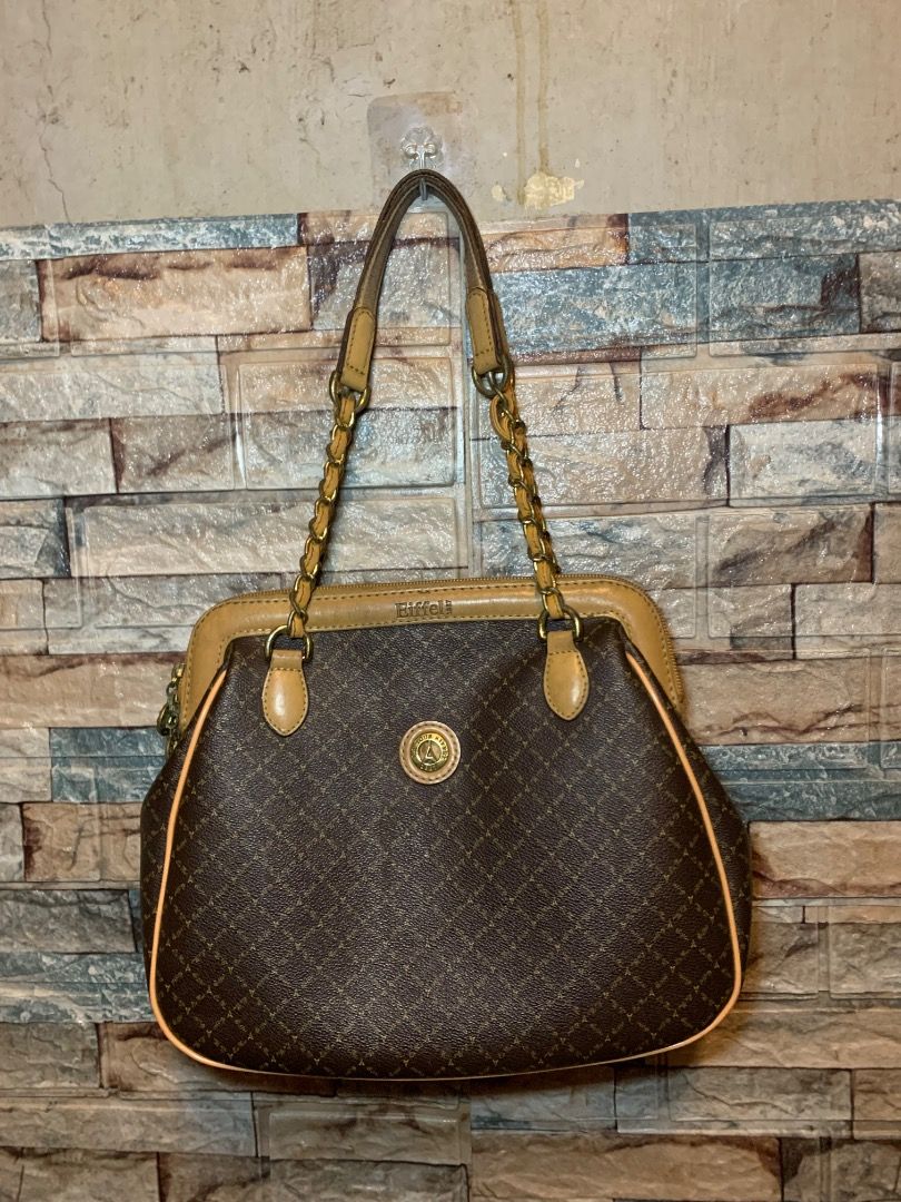 Eiffel Paris Monogram Shoulder Bag with Chain Straps (Category: Luxury Bags & Wallets) located in Pasay City. Submitted by bhibeboutique (Listing ID 1470722934, Image 1). Description: - Brand/Model: Eiffel Paris Brown Monogram Shoulder Bag - Material: Faux leather with classic monogram pattern - Handles: Stylish gold-tone chain mixed with faux leather - Compartments: Multiple inside compartments with fabric lining and a secure zip pocket - Closur