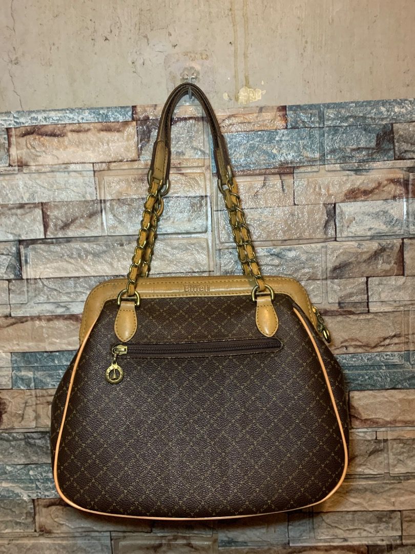 Eiffel Paris Monogram Shoulder Bag with Chain Straps (Category: Luxury Bags & Wallets) located in Pasay City. Submitted by bhibeboutique (Listing ID 1470722934, Image 2). Description: - Brand/Model: Eiffel Paris Brown Monogram Shoulder Bag - Material: Faux leather with classic monogram pattern - Handles: Stylish gold-tone chain mixed with faux leather - Compartments: Multiple inside compartments with fabric lining and a secure zip pocket - Closur