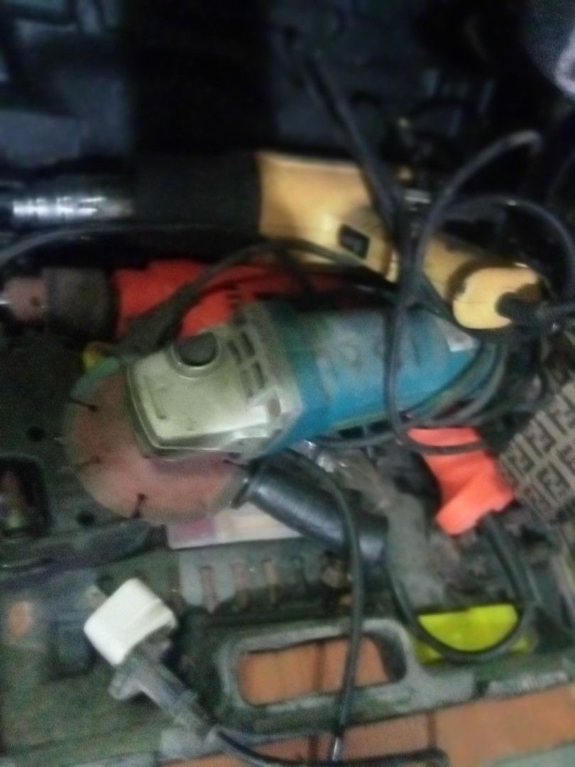 Electric angle grinder and power tools (Category: Construction Tools & Equipment) located in Paranaque City. Submitted by dimaguilaa24827 (Listing ID 1470653759, Image 1). Description: - Bundle includes: Blue angle grinder (with cutting disc), yellow drill, and red drill - Type: All corded electric models with included power cords and plugs - Condition: Used with normal job site wear and scuffs; untested recently but motors worked when last store