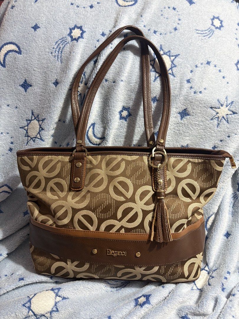 Elegance Brown Monogram Tote Bag with Tassel (Category: Tote Bags) located in Manila. Submitted by yanna1972 (Listing ID 1470700866, Image 1). Description: - price is negotiable for sure buyer - NO ISSUE 💓 - buy at ur own risk ! MOP: gcash or MariBank MOD : j&t and lalamove if within manila .