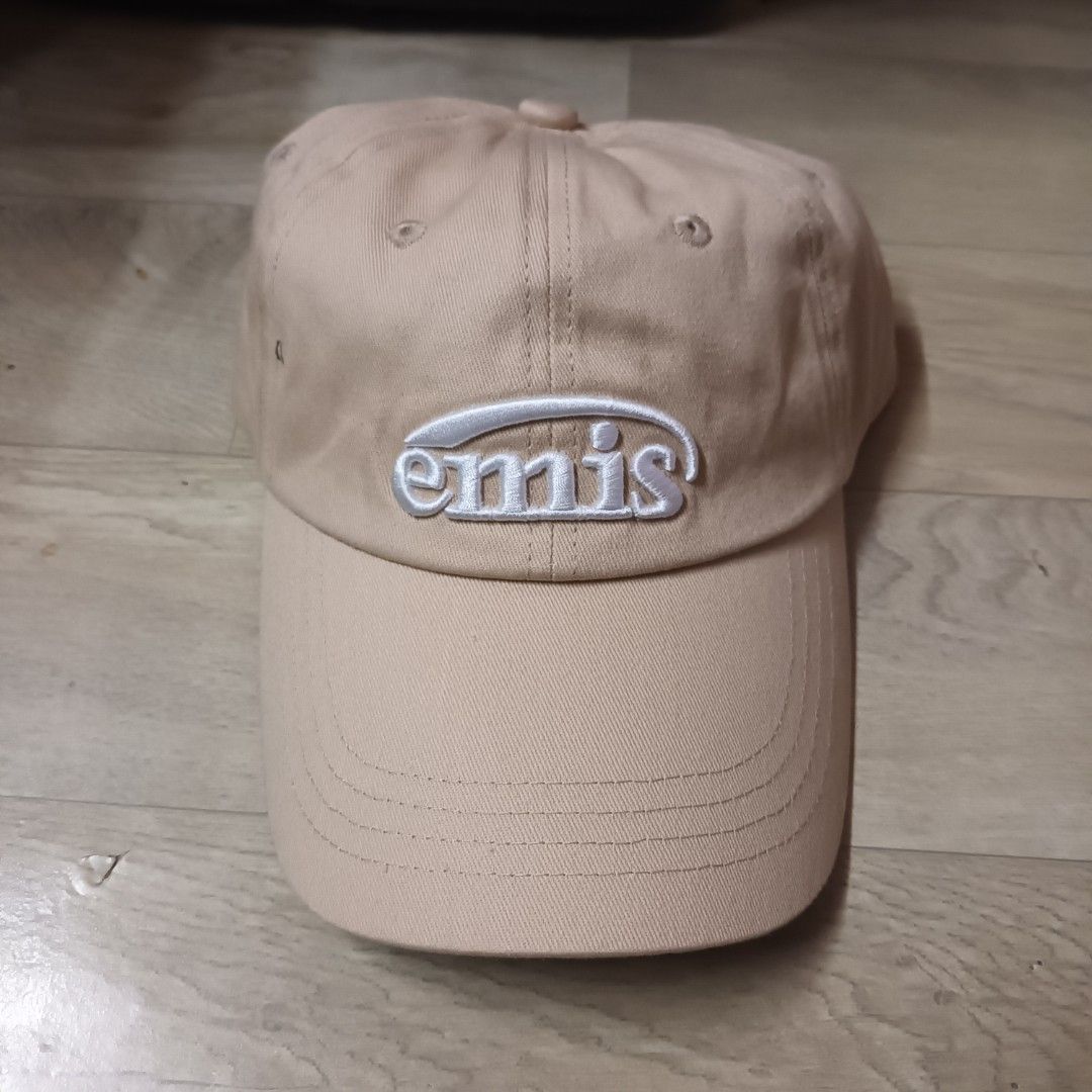 Emis Beige Footprint Cap (Category: Caps & Hats) located in Manila. Submitted by itsnik444 (Listing ID 1470640235, Image 1). Description: - Brand: Emis - Color: Classic Beige - Material: 100% Cotton - Design: White embroidered logo on the front - Fit: Adjustable strap at the back with secure metal hardware - Details: Interior features branded taping and authentic wash care tags - Condition: Clean structure with minimal wear.