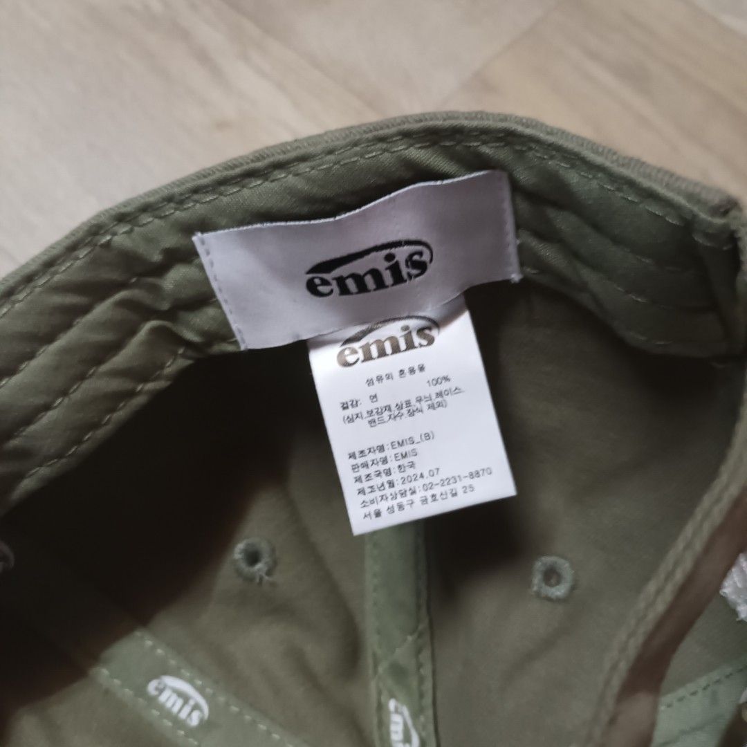 Emis Heart Logo Cap (Category: Caps & Hats) located in Manila. Submitted by itsnik444 (Listing ID 1470639818, Image 3). Description: - Brand: Emis - Color: Olive green - Design: Embroidered heart patch with 'emis' text and 'every moment is special' lettering - Material: 100% cotton - Closure: Adjustable strapback with branded metal buckle - Details: Branded interior taping and tag - Condition: Clean and ready to wear.