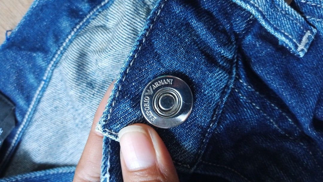 Emporio Armani Regular Fit Blue Jeans (Category: Jeans) located in Dumaguete. Submitted by morie_luna15 (Listing ID 1470682838, Image 3). Description: - Brand: Emporio Armani - Size: 29-30/length 40 - Fit: Regular fit, straight leg cut - Color/Wash: Classic blue denim with washed detailing - Details: Metal button closure with embossed branding, branded leather back patch, and signature metal eagle logo on the pocket - Condition: Clean stitching a