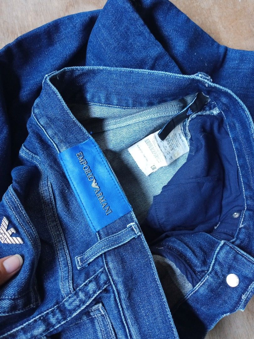 Emporio Armani Regular Fit Blue Jeans (Category: Jeans) located in Dumaguete. Submitted by morie_luna15 (Listing ID 1470682838, Image 2). Description: - Brand: Emporio Armani - Size: 29-30/length 40 - Fit: Regular fit, straight leg cut - Color/Wash: Classic blue denim with washed detailing - Details: Metal button closure with embossed branding, branded leather back patch, and signature metal eagle logo on the pocket - Condition: Clean stitching a