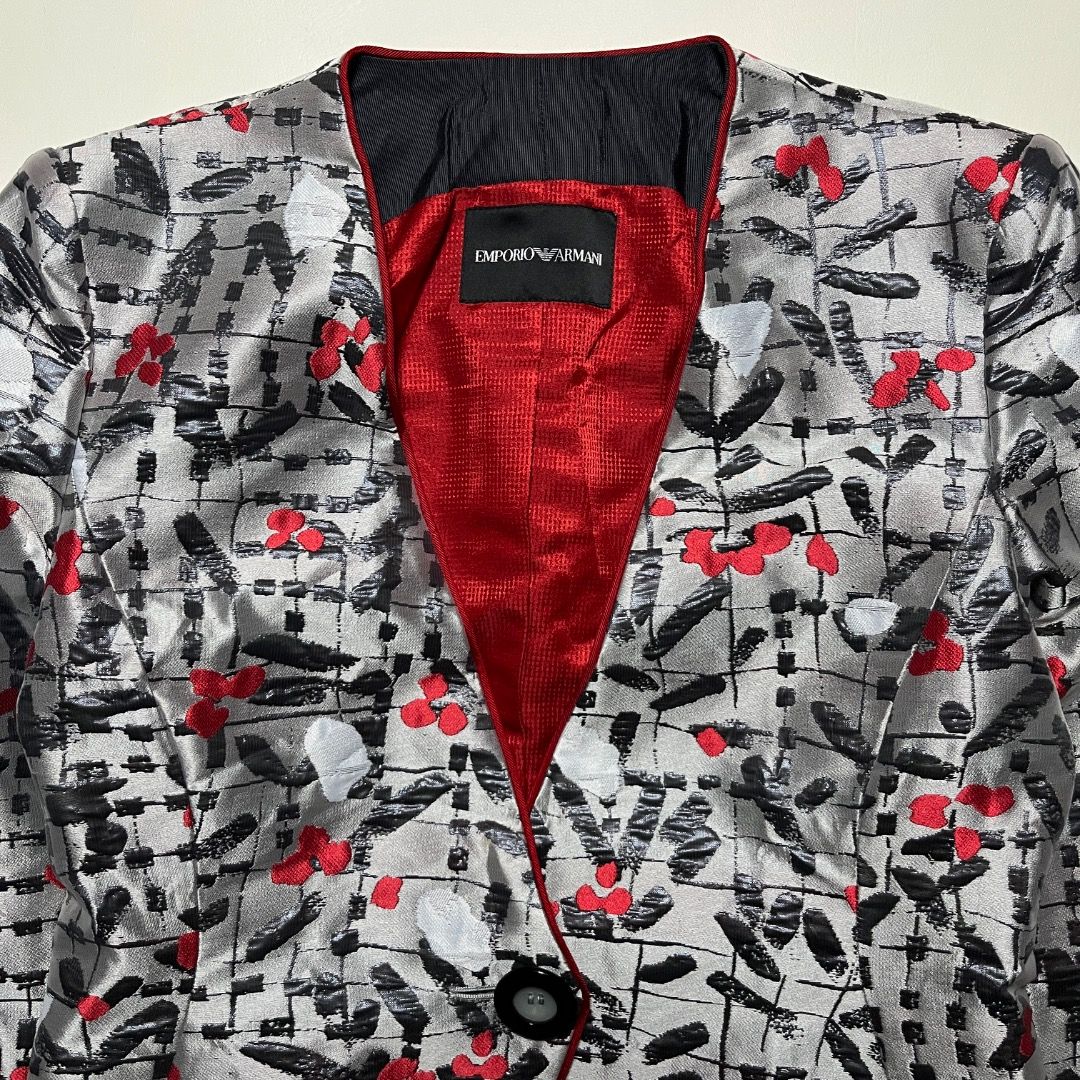 Emporio Armani Silver Red Patterned Blazer Jacket (Category: Coats, Jackets and Outerwear) located in Caloocan City. Submitted by achilles_grails (Listing ID 1470728063, Image 2). Description: - Brand: Emporio Armani designer blazer - Color/Pattern: Silver grey base with black abstract strokes and bright red floral accents - Design: Collarless neckline, single-button front closure, and curved hem - Lining: Striking red textured interior lining - 