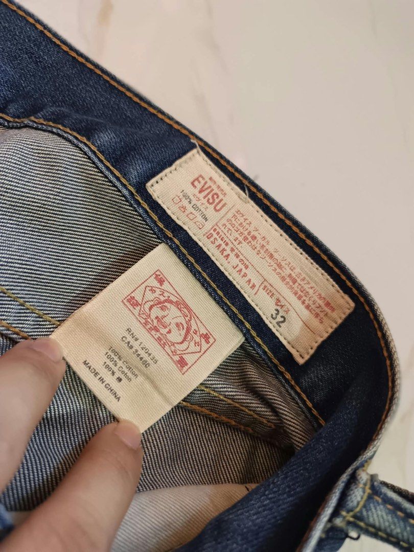 Evisu 2000 Yellow Seagull Denim Jeans Size 32 (Category: Jeans) located in Bustos. Submitted by thenlnclot60500 (Listing ID 1470650998, Image 3). Description: - Brand: Evisu Model 2000 - Size: 32 - Fit: Classic straight leg - Wash: Medium blue with subtle distressing and whiskering - Details: Iconic yellow seagull print on back pockets, button fly closure - Authenticity: Leather back patch, interior cotton waist label, and care tags included - Co
