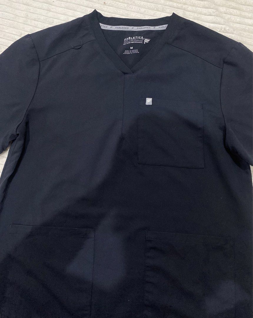 Fabletics scrub top (Category: Activewear) located in Tanza. Submitted by 9th.street.thrift (Listing ID 1470595664, Image 2). Description: Fabletics scrub top unisex Good as new Same as figs tela Black No issue M on tag 21.5x28.5.
