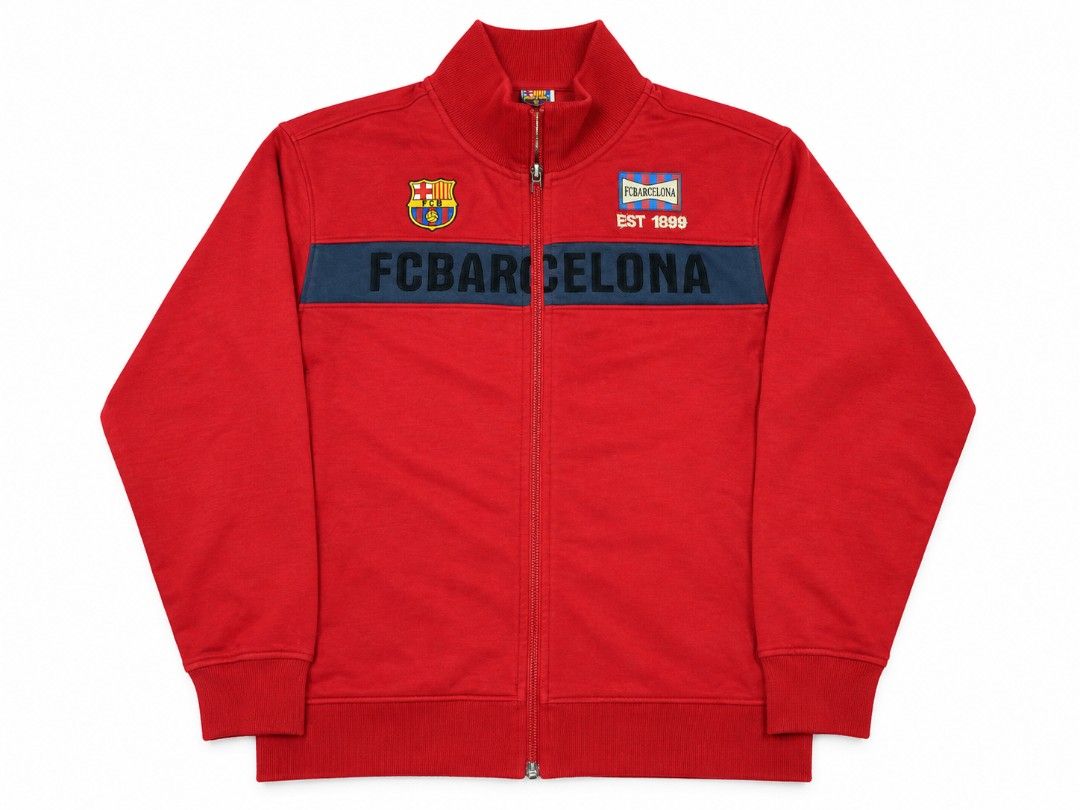 FC Barcelona Red Full-Zip Track Jacket (Category: Coats, Jackets and Outerwear) located in Bauang. Submitted by mr.acey (Listing ID 1470679071, Image 3). Description: - Item: Official FC Barcelona Full-Zip Track Jacket - Color: Vibrant Red with Dark Blue chest stripe - Details: Embroidered team crest, special EST 1899 patch, and bold FC BARCELONA lettering - Fit: Stand-up collar and ribbed cuffs for extra comfort - Condition: Great piece for coll
