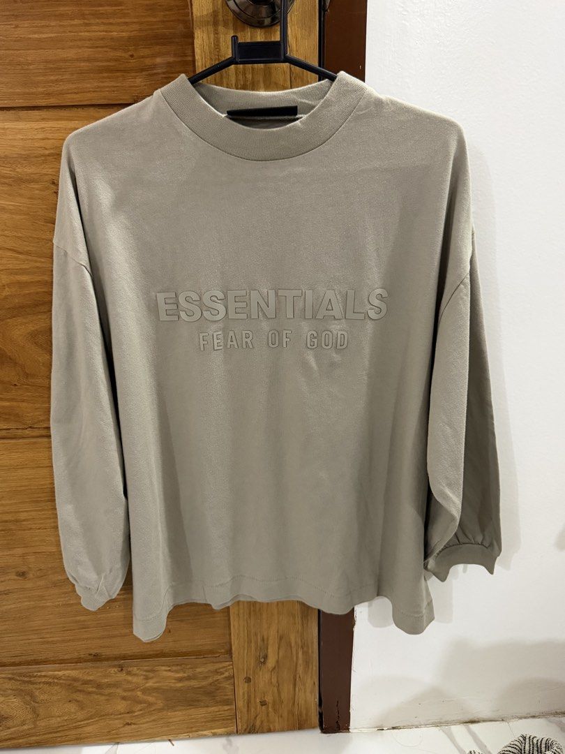 Fear of God Essentials Long Sleeve Tee (Category: Coats, Jackets and Outerwear) located in Naga. Submitted by oldthangs13 (Listing ID 1470682073, Image 1). Description: - Brand: Fear of God Essentials - Color: Light khaki / Taupe - Size: 14/16 (inner tag) - Condition: Like new -Authentic .