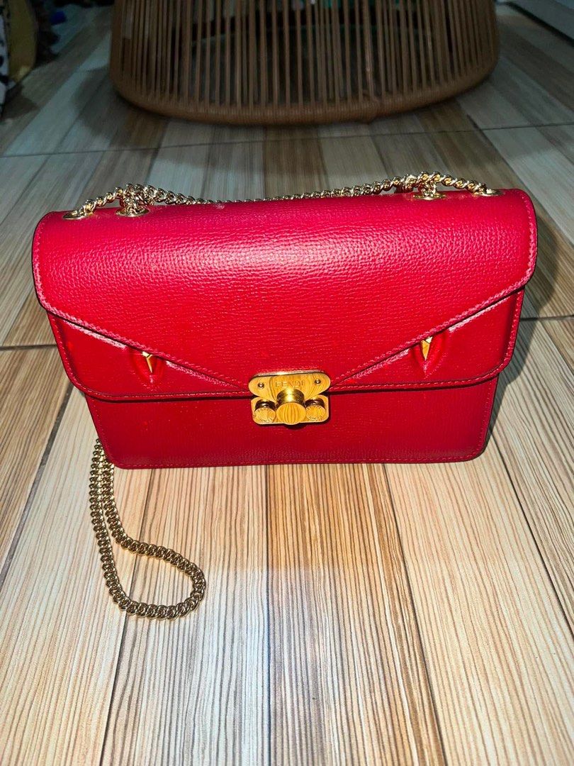 Fendi Kan I Red Leather Shoulder Bag (Category: Luxury Bags & Wallets) located in Dagupan City. Submitted by makilux.ph (Listing ID 1470635084, Image 2). Description: - Authentic Fendi shoulder bag in bold red textured leather - Elegant gold-tone chain strap and matching hardware - Flap closure with iconic signature twist lock and edgy conical stud accents - Luxurious grey suede interior lining featuring the classic FF logo fabric pattern - Conve
