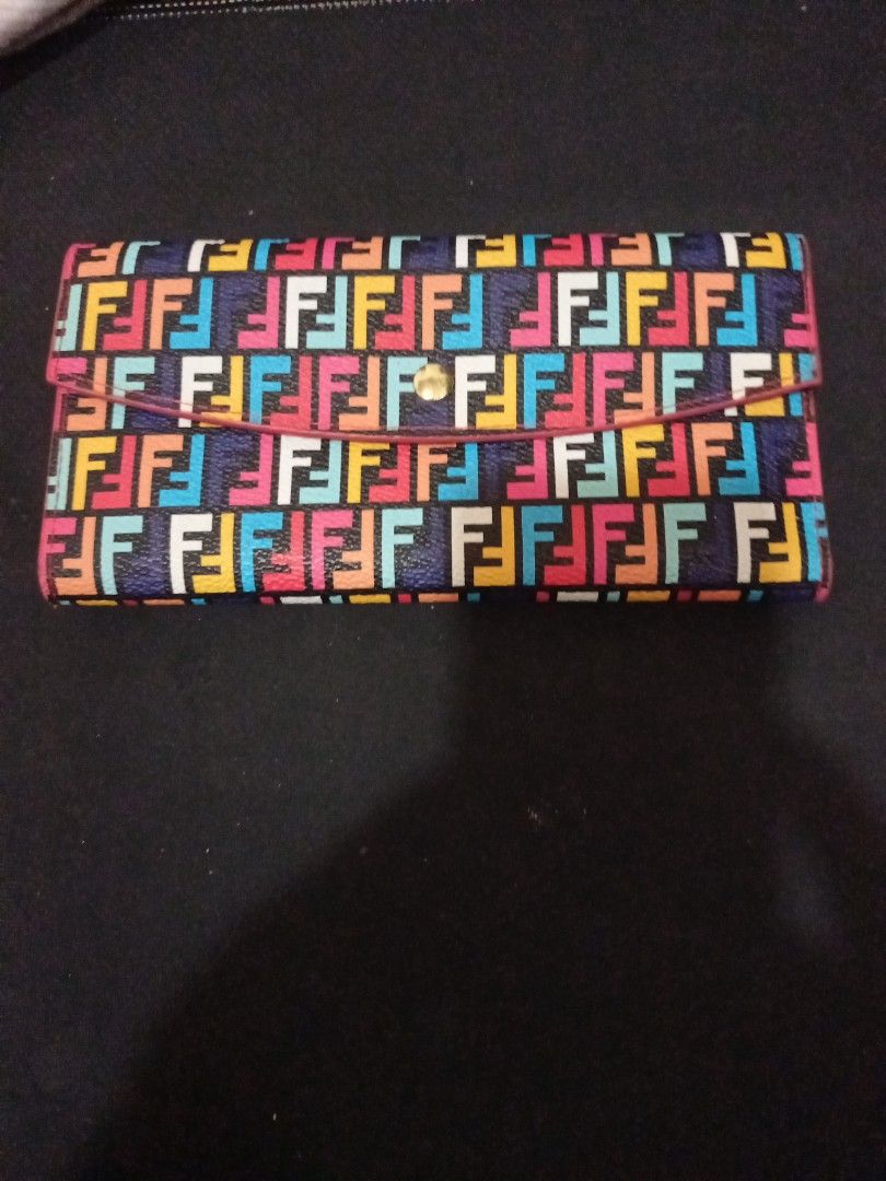 Fendi Roma Multi-color Monogram Long Wallet (Category: Luxury Bags & Wallets) located in Manila. Submitted by luckyeagle-7ff8 (Listing ID 1470588676, Image 2). Description: - Authentic Fendi Roma long wallet with colorful multi F monogram print - Eye-catching bright pink interior lining - Features multiple card slots, slip pockets, and a secure zippered coin compartment - Elegant gold-tone hardware with Fendi logo pull and snap button closure - I