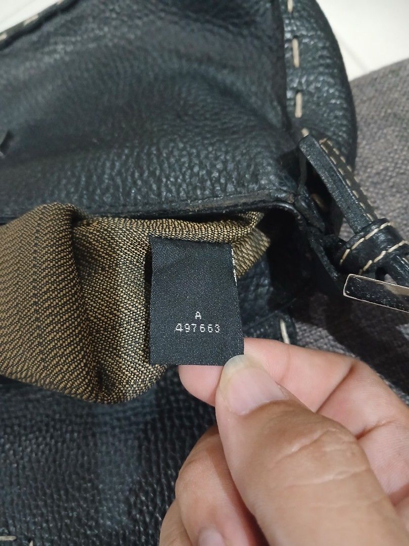 Fendi Selleria Black Leather Bag (Category: Luxury Bags & Wallets) located in Daraga. Submitted by thethriftcity2024 (Listing ID 1470683753, Image 2). Description: - Fendi black textured leather handbag - Iconic gold/silver-tone FF metal clasp on the front flap - Stylish contrast stitching along the edges - Chic single top handle design - Secure zipped interior compartment - Features Fendi 'Made In Italy' metal plaque and serial number tags - Con