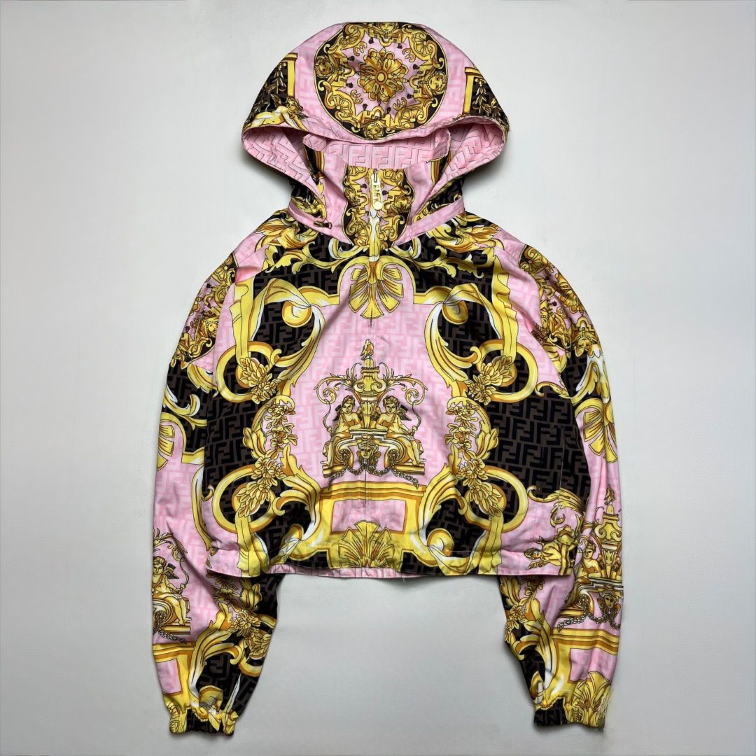 Fendi Versace Pink Reversible Hooded Jacket (Category: Coats, Jackets and Outerwear) located in Caloocan City. Submitted by achilles_grails (Listing ID 1470574830, Image 1). Description: - Brand: Fendi - Design 1: Pink with allover FF monogram pattern - Design 2: Fully reversible with bold gold baroque and cherub print - Features: High collar, full zip closure, custom branded zipper pull - Fit: Relaxed fit, lightweight material - Origin: Made in 
