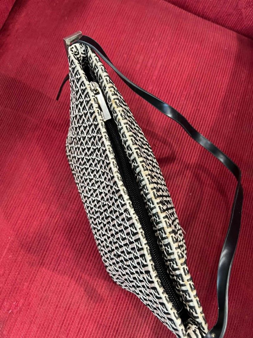 Fendi Zucchino Monogram Shoulder Bag (Category: Luxury Bags & Wallets) located in Urdaneta. Submitted by jayceegarage (Listing ID 1470691254, Image 3). Description: - Fendi Zucchino monogram pattern in black and white - Durable black leather strap with silver-tone hardware and Fendi logo engraving - Secure top zipper closure with clean fabric interior lining - Compact size, perfect for daily essentials - Condition: Minor yellowing along the top e