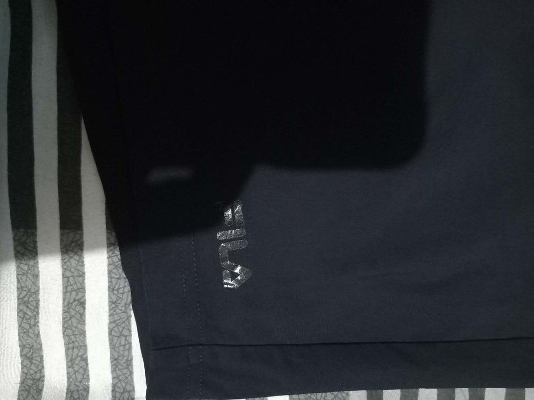 FILA Black Athletic Shorts with Drawstring (Category: Shorts) located in Panabo. Submitted by khimmyirish_ki021126 (Listing ID 1470582397, Image 2). Description: - Brand: FILA - Color: Classic Black - Material: Lightweight and breathable - Fit: Elastic waistband with adjustable drawstring - Pockets: Convenient side pockets and back pocket detail - Branding: FILA logo near the hem - Condition: Excellent / Pre-loved (ready to wear) - Best for: Gym 