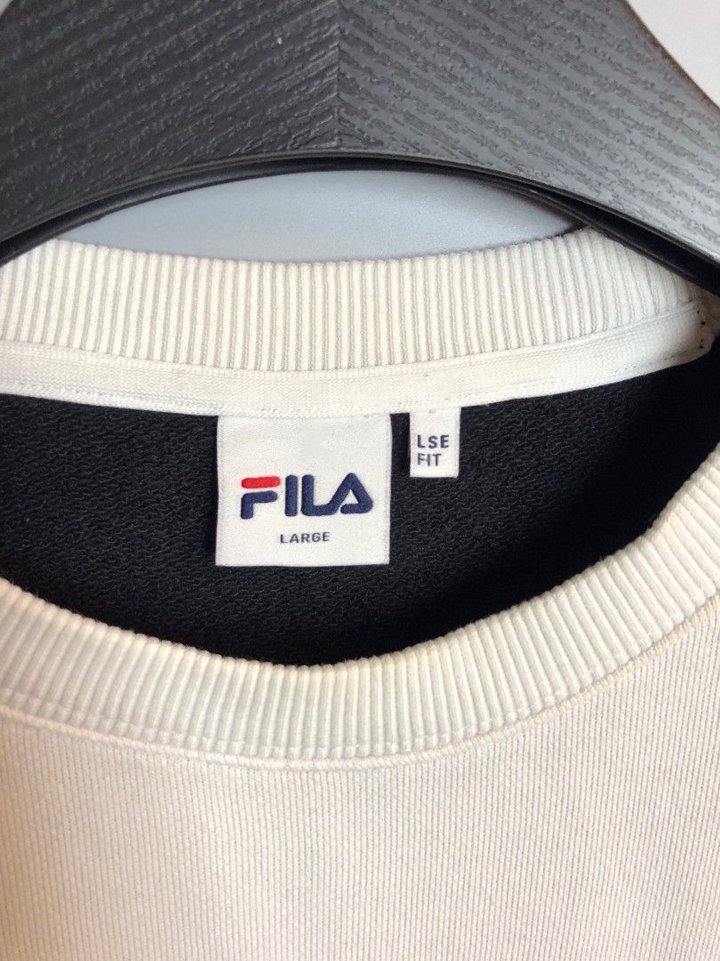 FILA Colourblock Crewneck Sweatshirt Large (Category: Coats, Jackets and Outerwear) located in Manila. Submitted by silentwolf_3303a7 (Listing ID 1470559158, Image 2). Description: - Brand: FILA - Design: White, orange, and black colourblock with a large diagonal front logo and sleeve patch - Interior: Thick fleece lining for extra warmth and comfort - Fit: Size Large (LSE fit) - Details: Ribbed collar, cuffs, and hem with original Korean care la