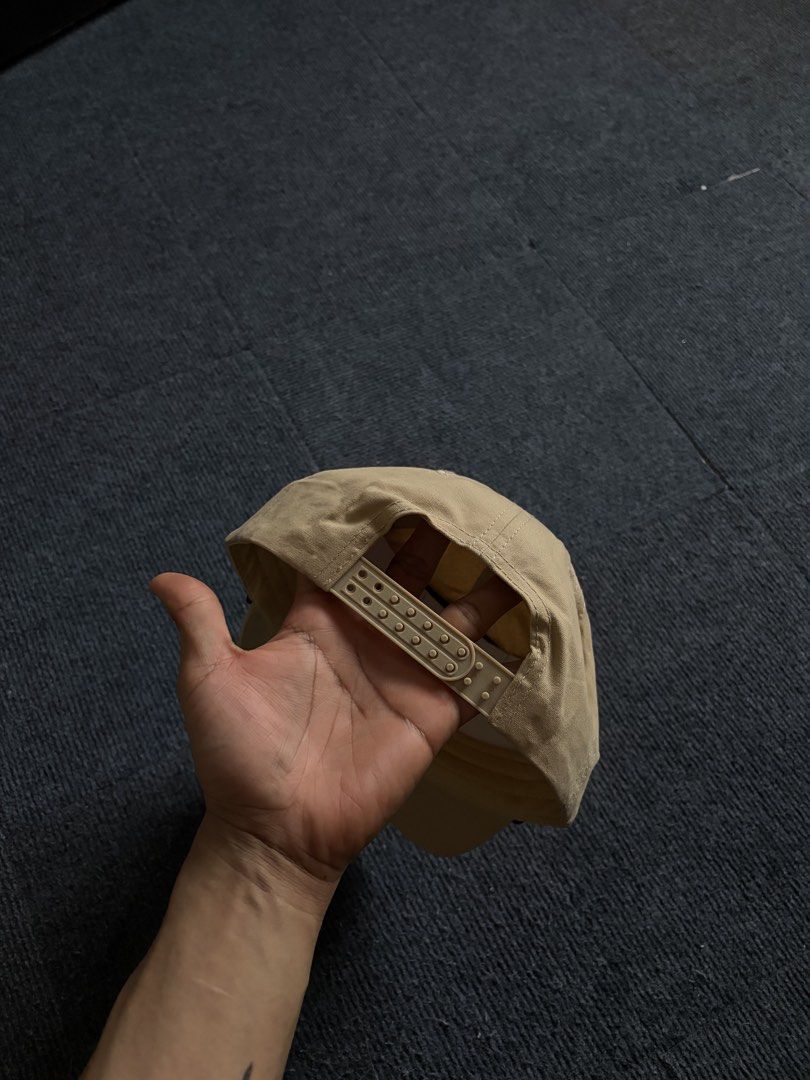 Flores Cattle Co. Snapback Hat Beige (Category: Caps & Hats) located in Manila. Submitted by toys_hats005 (Listing ID 1470629245, Image 2). Description: - Brand: Flores Cattle Co. - Color: Classic beige with brown embroidered front text and longhorn graphic - Detail: Unique braided cord across the brim base - Fit: Adjustable snapback closure for a customized fit - Condition: Brand new, unworn, with original white paper insert inside for structure