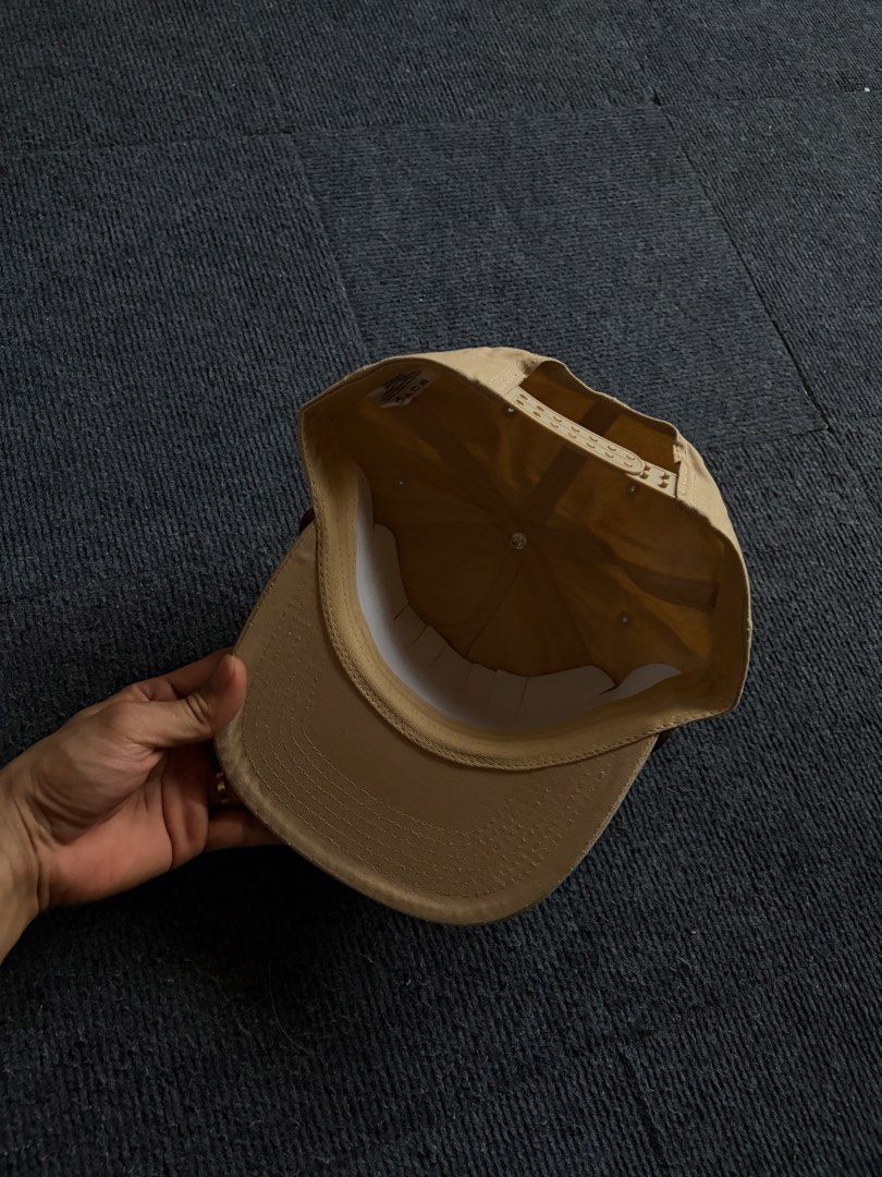Flores Cattle Co. Snapback Hat Beige (Category: Caps & Hats) located in Manila. Submitted by toys_hats005 (Listing ID 1470629245, Image 3). Description: - Brand: Flores Cattle Co. - Color: Classic beige with brown embroidered front text and longhorn graphic - Detail: Unique braided cord across the brim base - Fit: Adjustable snapback closure for a customized fit - Condition: Brand new, unworn, with original white paper insert inside for structure