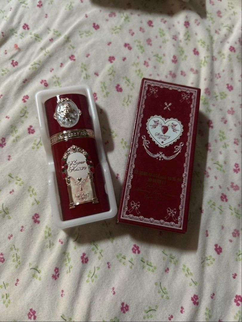 Flower Knows Strawberry Cupid Liquid Blush (Category: Makeup) located in Manila. Submitted by itsyohg_szaestarrr (Listing ID 1470708685, Image 2). Description: - Brand: Flower Knows - Collection: Strawberry Cupid Liquid Blush - Packaging: Dark red with ornate gold detailing, cherry, and cupid motifs - Condition: Unused and clean - Inclusions: Comes with original outer box and inner plastic tray packaging.