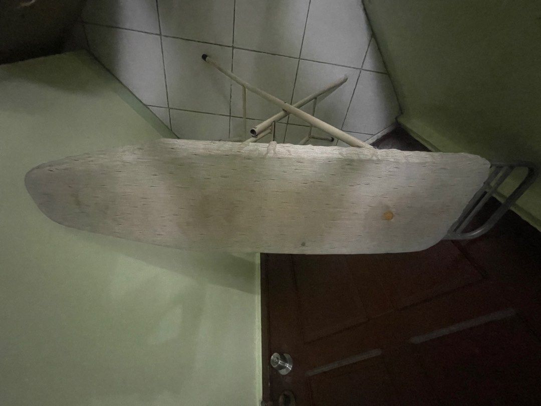 Foldable Ironing Board with Stand (Category: Ironing Boards) located in Manila. Submitted by pasaybestfinds (Listing ID 1470708225, Image 2). Description: - Type: Standard collapsible ironing board - Frame: Sturdy metal with built-in iron rest at the back - Cover: Padded fabric (shows normal signs of wear and tear) - Storage: Folds completely flat for easy storage behind doors or in closets - Condition: Good, fully functional pre-loved item.