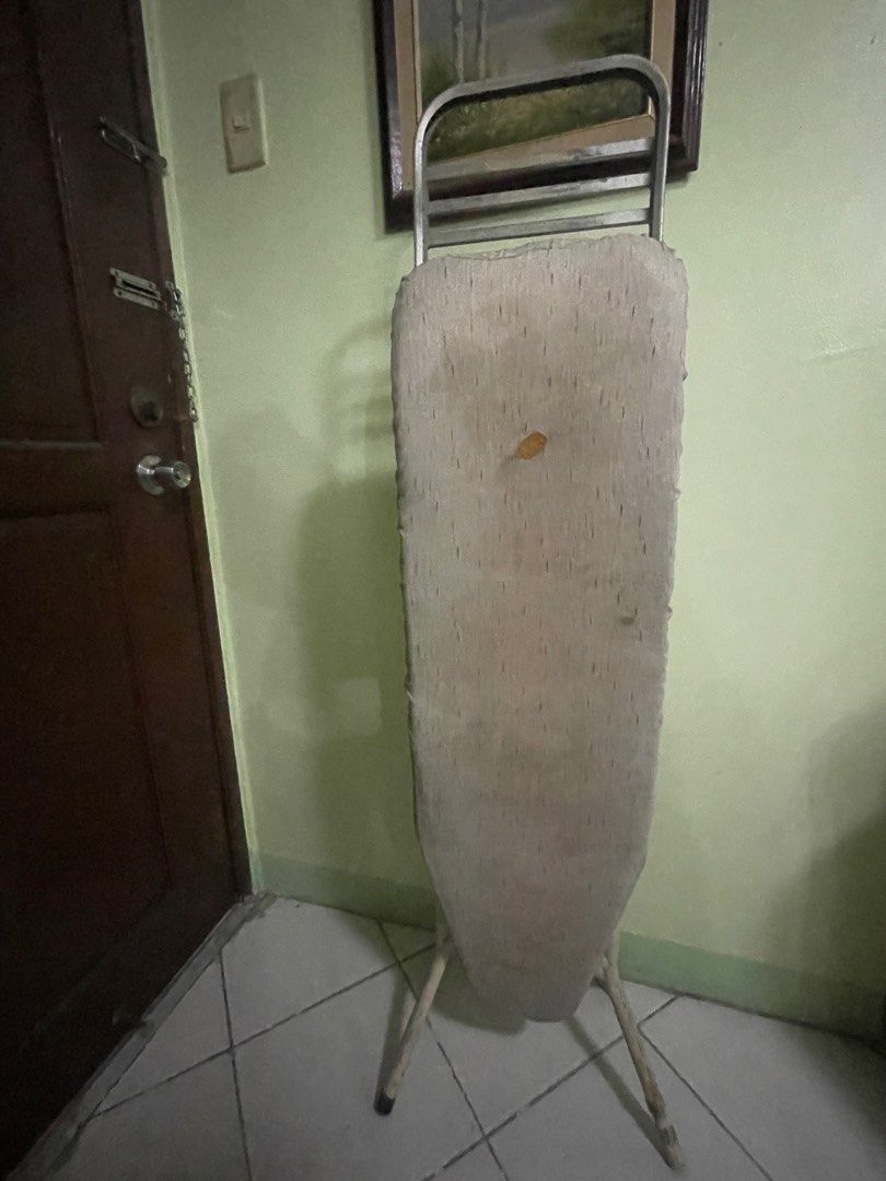 Foldable Ironing Board with Stand (Category: Ironing Boards) located in Manila. Submitted by pasaybestfinds (Listing ID 1470708225, Image 1). Description: - Type: Standard collapsible ironing board - Frame: Sturdy metal with built-in iron rest at the back - Cover: Padded fabric (shows normal signs of wear and tear) - Storage: Folds completely flat for easy storage behind doors or in closets - Condition: Good, fully functional pre-loved item.
