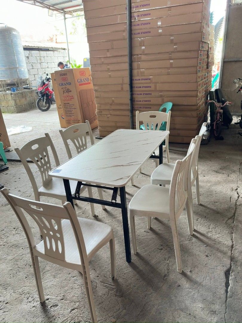 Folding Dining Table With 6 Chairs Set (Category: Tables & Sets) located in Manila. Submitted by omsiminingiri3122 (Listing ID 1470683056, Image 1). Description: - Elegant white marble-design tabletop paired with sleek black metal legs - Includes 6 matching foldable plastic chairs with stylish patterned backrests - Space-saving foldable design allows for quick and easy storage when not in use - Versatile styling suitable for both indoor dining ar