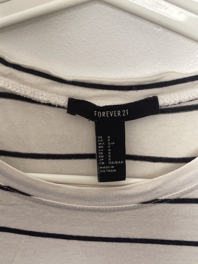 Forever 21 Black and White Striped Crop Top (Category: Shirts) located in Manila. Submitted by lovedbymidge (Listing ID 1470645136, Image 2). Description: 🩷 for xs-s girlies 🚚 lalamove or grab express (sf shouldered by the buyer!) - Brand: Forever 21 - Size: S (US sizing) - Color: White with horizontal black stripes - Material: Soft stretch cotton - Neckline: Scoop neck - Fit: Cropped length, pairs easily with high-waisted jeans or skirts - Con