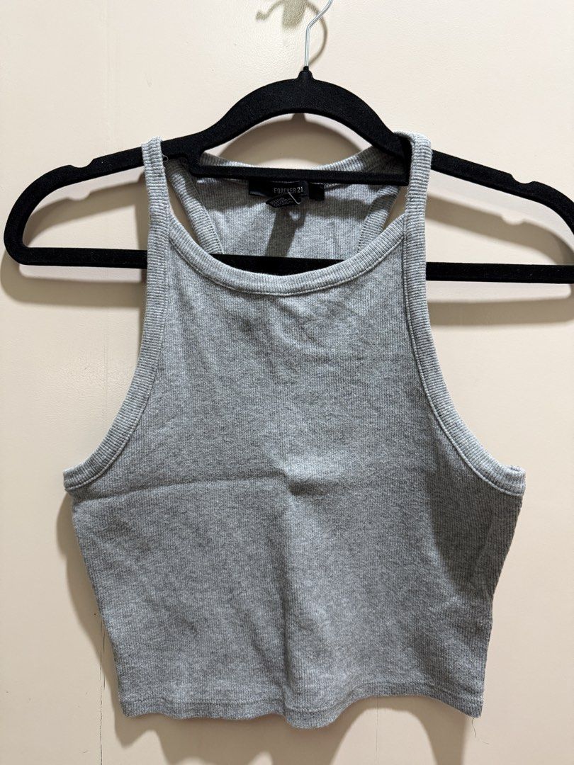 Forever 21 Grey Ribbed Tank Top (Category: Sleeveless) located in Davao. Submitted by 2ndbase.dvo.ii (Listing ID 1470597548, Image 2). Description: - Brand: Forever 21 - Color: Grey - Size: Small - Style: Racerback, ribbed crop top - Fit: Fitted and stretchy - Condition: Great basic piece for layering or standalone wear.