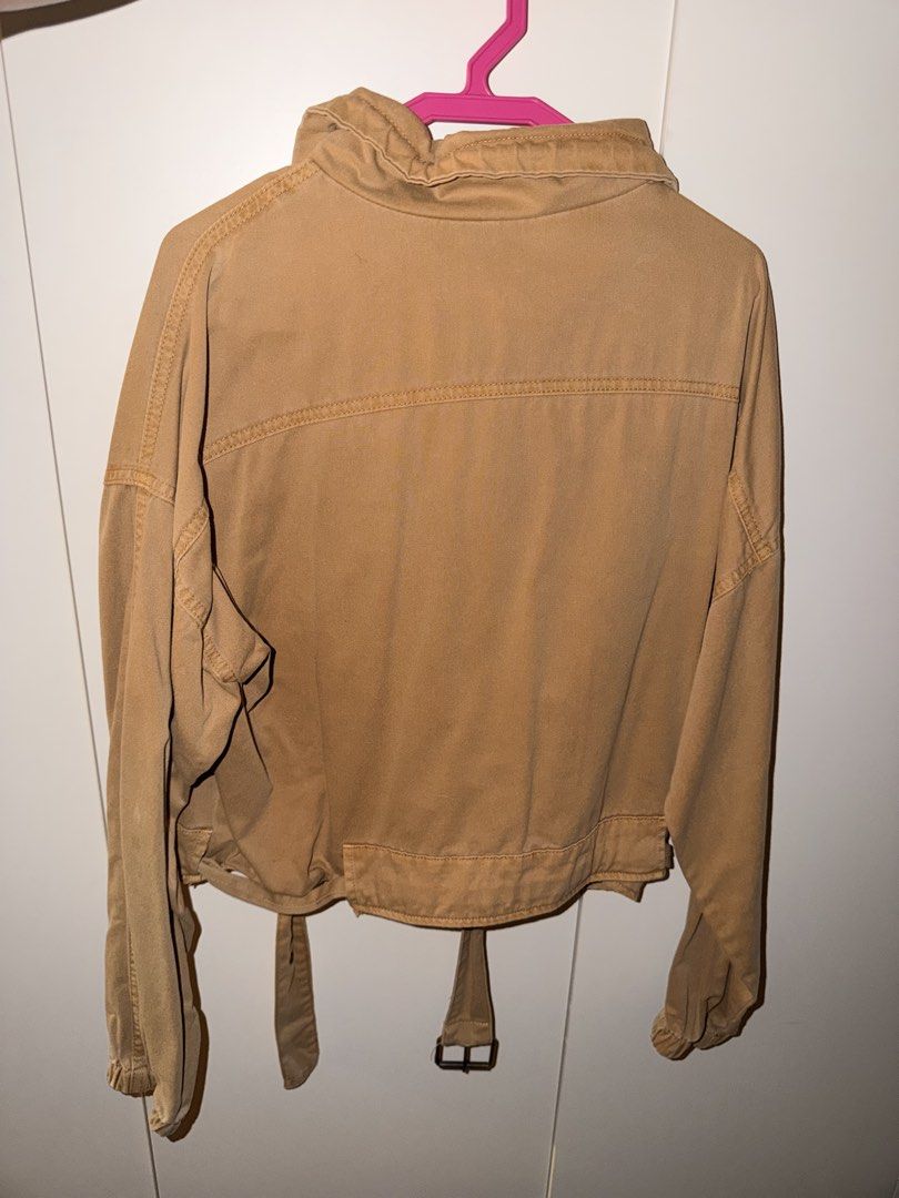 Forever 21 Khaki Cropped Zip Jacket Size XS (Category: Coats, Jackets and Outerwear) located in Manila. Submitted by kacee18 (Listing ID 1470702582, Image 2). Description: - Brand: Forever 21 Contemporary - Color: Khaki - Size: XS fits until S *oversized vibe - Closure: Full front zip - Details: Wide collar, two chest flap pockets, adjustable buckle belt at hem, elasticized cuffs - Condition: Great layering piece for casual outfits.