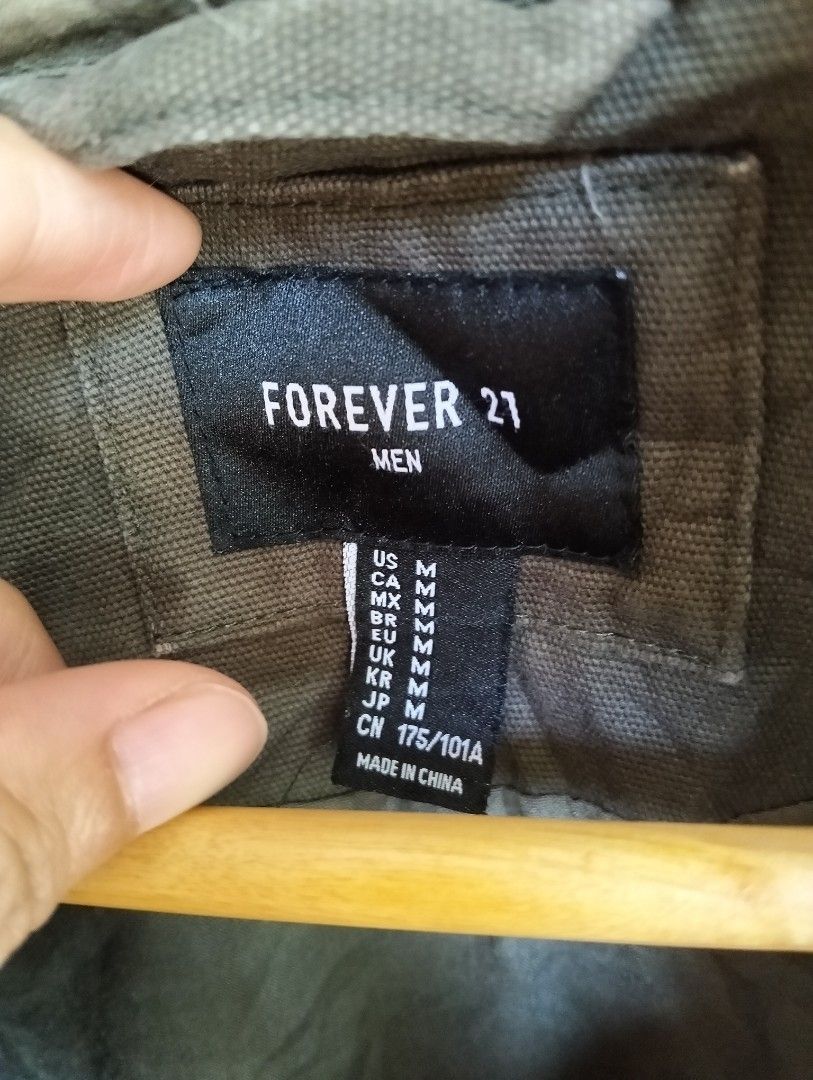 Forever 21 Men Military Field Jacket / Parka (Category: Coats, Jackets and Outerwear) located in Malolos. Submitted by rthrift2026 (Listing ID 1470602338, Image 2). Description: Size: Medium • Color: Olive Green / Military Green • Material: 100% Cotton Shell • Features: With hood, multi-pocket utility design, button and zipper closure.
