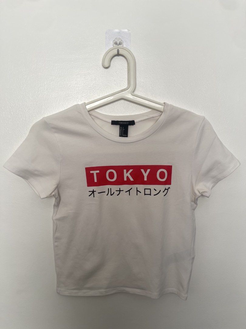 Forever 21 Tokyo Graphic Crop Top Size S (Category: Shirts) located in Manila. Submitted by lovedbymidge (Listing ID 1470644710, Image 1). Description: 🩷 for xs-m girlies 🚚 lalamove or grab express (sf shouldered by the buyer!) - Brand: Forever 21 - Item: White cropped t-shirt - Design: Red box logo with TOKYO text and Japanese characters - Details: Short sleeves, crew neckline - Size: S (fits true to size) - Condition: Great casual piece for e