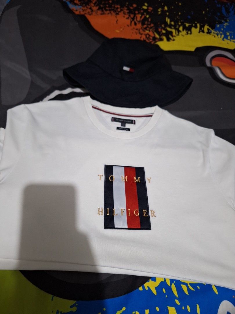 Forsale aspack. Size large (Category: Tshirts & Polo Shirts ) located in Manila. Submitted by adolphreyes645 (Listing ID 1470604362, Image 2). Description: - Brand: Tommy Hilfiger - Size: L - Material: 100% Organic Cotton - Color: Crisp White - Design: Classic embroidered flag logo box with gold lettering on the front - Details: Crew neck with signature interior striped tape - Condition: Excellent/Clean look - Style: Casual everyday staple, great