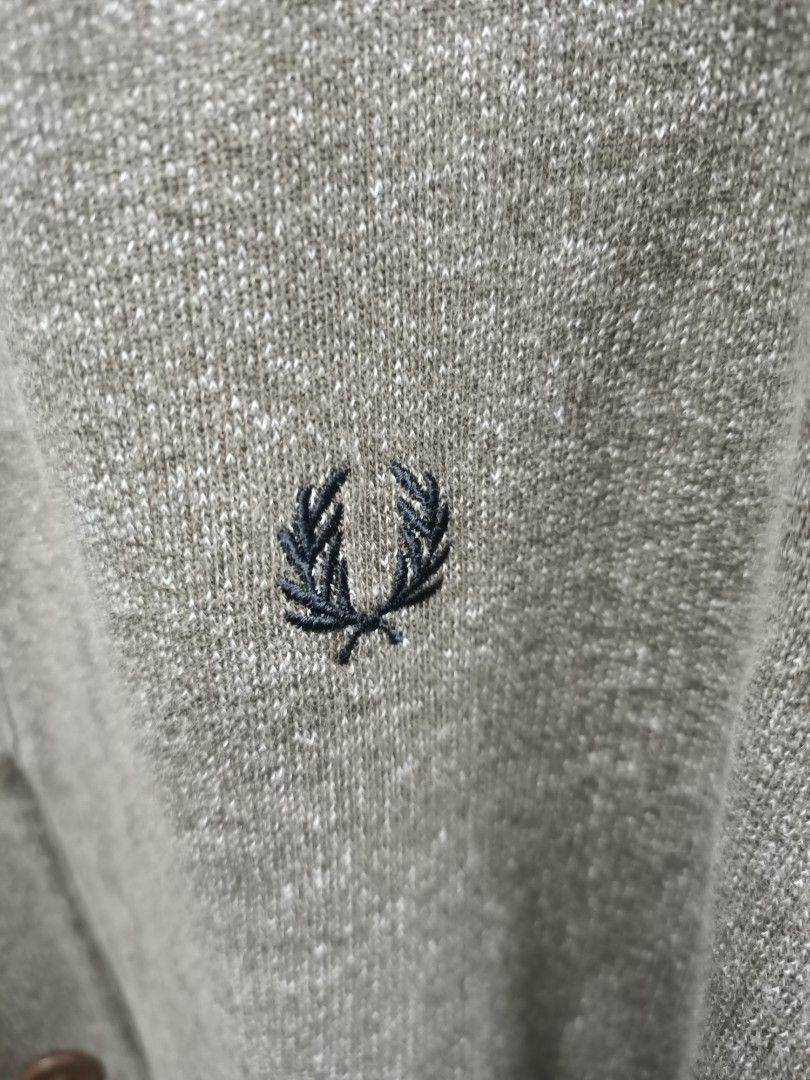 Fred Perry Cardigan Sweater Jacket Size L (Category: Coats, Jackets and Outerwear) located in Bayombong. Submitted by rheaaa00530 (Listing ID 1470664630, Image 3). Description: - Brand: Fred Perry - Item: Cardigan Jacket - Color: Heather Grey - Size: Large - Material: 100% Cotton (Made in Portugal) - Design: Button-down front with brown buttons, two front pockets, and blue plaid inner collar lining - Branding: Embroidered laurel wreath logo on th