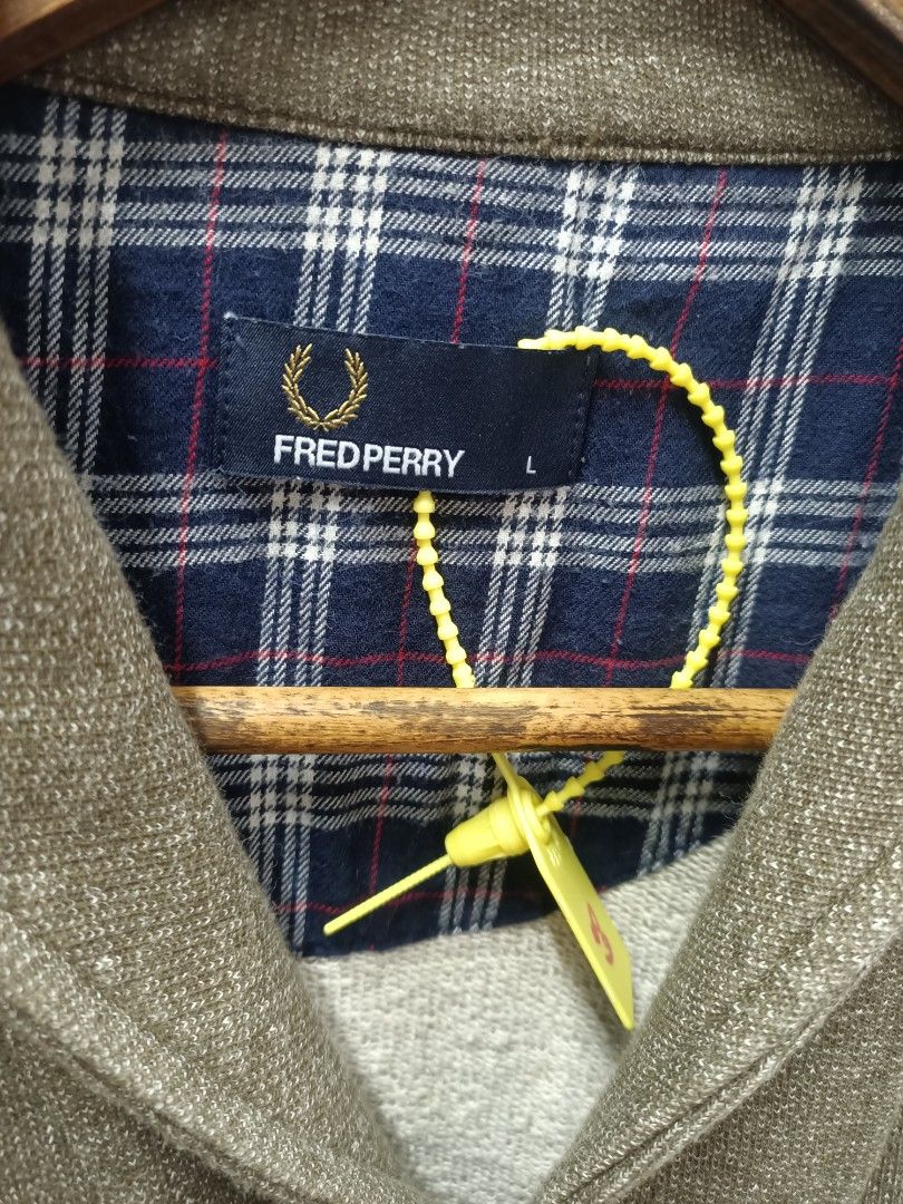 Fred Perry Cardigan Sweater Jacket Size L (Category: Coats, Jackets and Outerwear) located in Bayombong. Submitted by rheaaa00530 (Listing ID 1470664630, Image 2). Description: - Brand: Fred Perry - Item: Cardigan Jacket - Color: Heather Grey - Size: Large - Material: 100% Cotton (Made in Portugal) - Design: Button-down front with brown buttons, two front pockets, and blue plaid inner collar lining - Branding: Embroidered laurel wreath logo on th