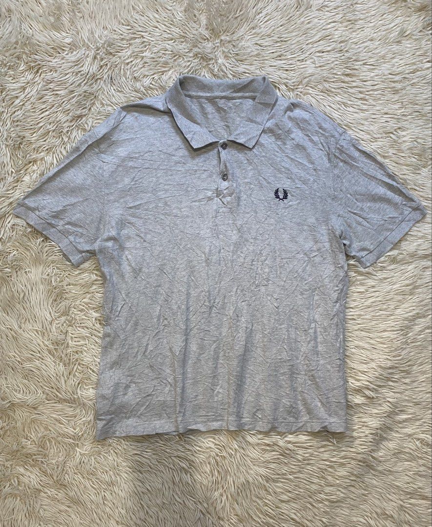 Fred Perry Grey Polo Shirt (Category: Tshirts & Polo Shirts ) located in Antipolo. Submitted by switchneighborhood (Listing ID 1470634404, Image 1). Description: - Brand: Fred Perry - Color: Grey - Material: 100% Cotton - Fit: Standard fit 22/28 measurement - Features: Classic collar, branded buttons, ribbed cuffs and hem - Logo: Iconic embroidered laurel wreath on chest - Care: Machine washable - Origin: Made in China.