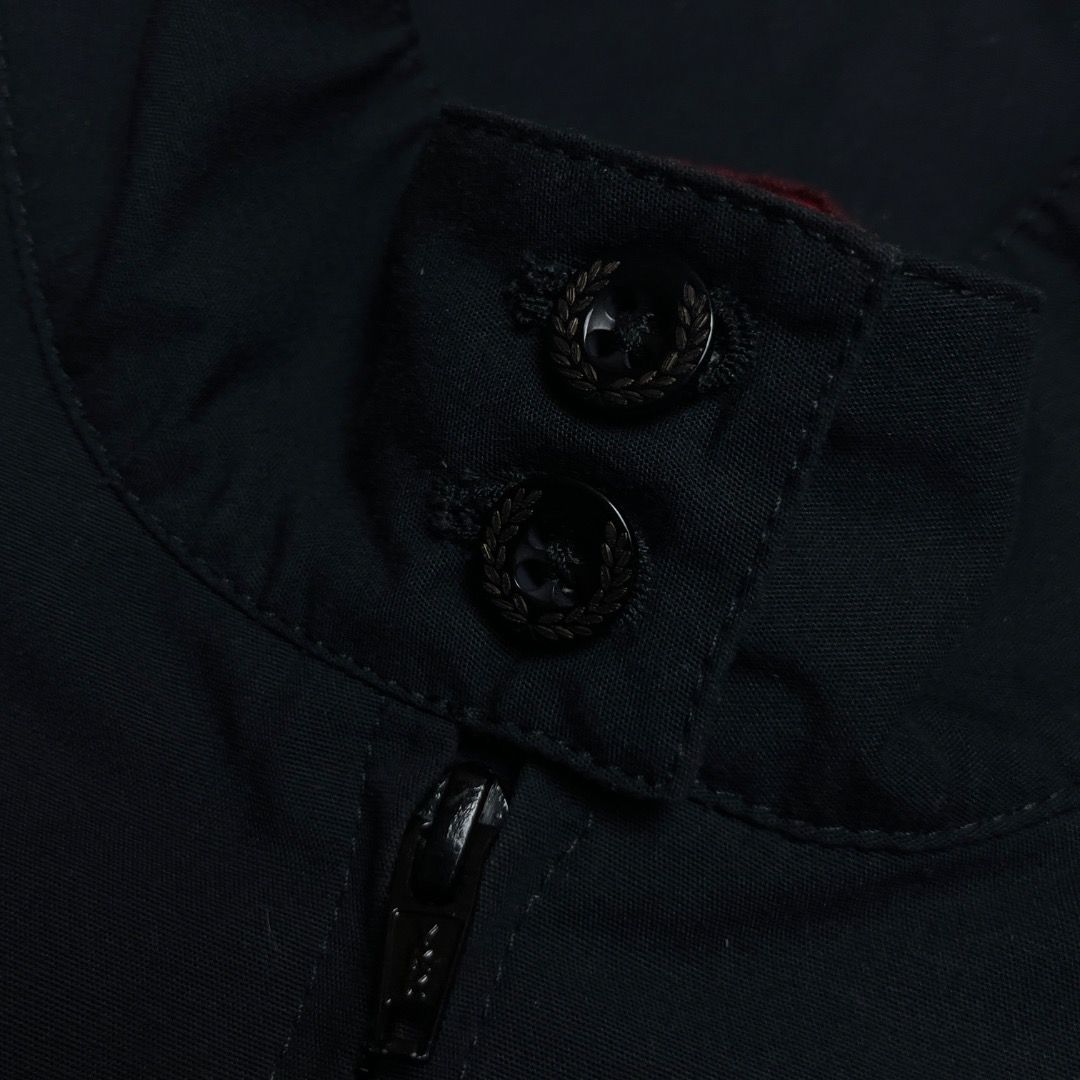 Fred Perry Harrington Jacket Black Made in England (Category: Coats, Jackets and Outerwear) located in Caloocan City. Submitted by achilles_grails (Listing ID 1470578868, Image 3). Description: - Authentic Fred Perry Harrington jacket in classic black, Made in England - Features iconic red tartan inner lining and signature embroidered laurel wreath on chest - High collar with double button fastening, full zip front, and ribbed cuffs and hem - She