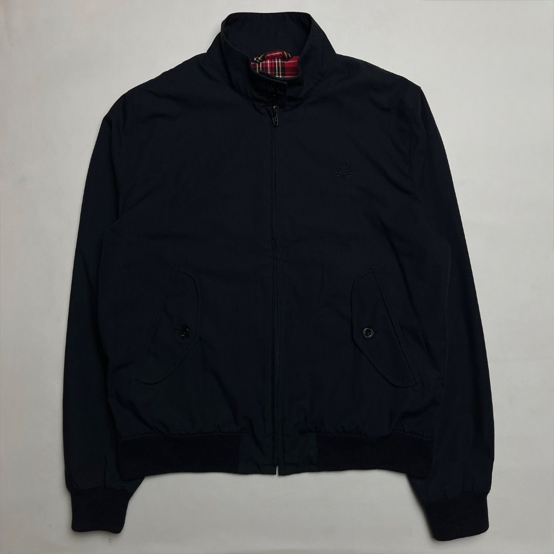 Fred Perry Harrington Jacket Black Made in England (Category: Coats, Jackets and Outerwear) located in Caloocan City. Submitted by achilles_grails (Listing ID 1470578868, Image 1). Description: - Authentic Fred Perry Harrington jacket in classic black, Made in England - Features iconic red tartan inner lining and signature embroidered laurel wreath on chest - High collar with double button fastening, full zip front, and ribbed cuffs and hem - She